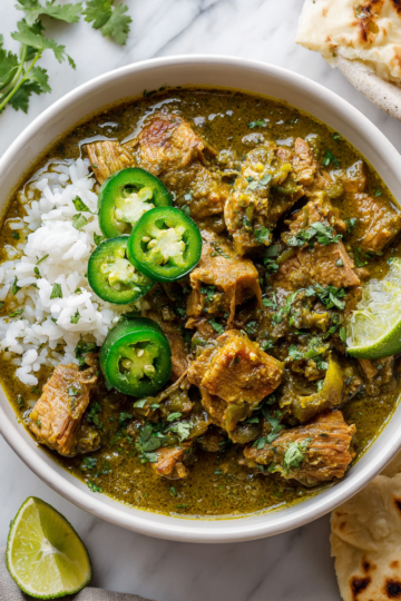 Delicious Slow Cooker Pork Chili Verde garnished with cilantro, perfect for family gatherings and hearty meals, featuring tender pork and tomatillos.