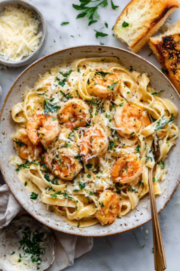 Creamy Parmesan Garlic Shrimp Pasta garnished with parsley, an elegant and comforting dish perfect for festive gatherings, ready in 30 minutes.